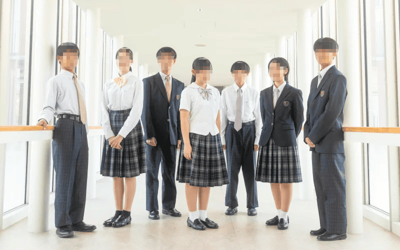中村学園高等学校の新制服を着た生徒たちが廊下に並んでいる写真